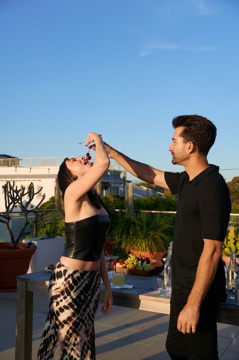 A daytime rooftop moment, feeding cherries