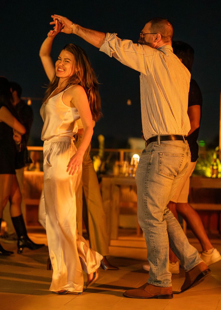 A twirl on the rooftop dance floor at night